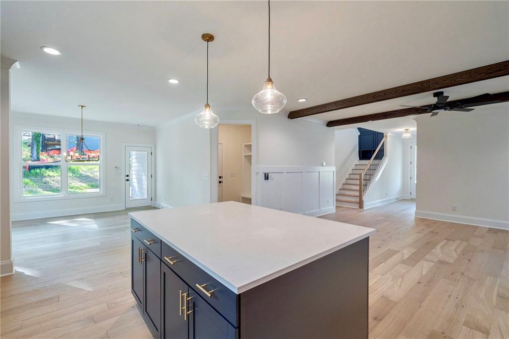 1709 Eastside Parc Street Atlanta, GA 30316 - Photo 18 of 38 a kitchen with kitchen island a sink appliances and wooden floor