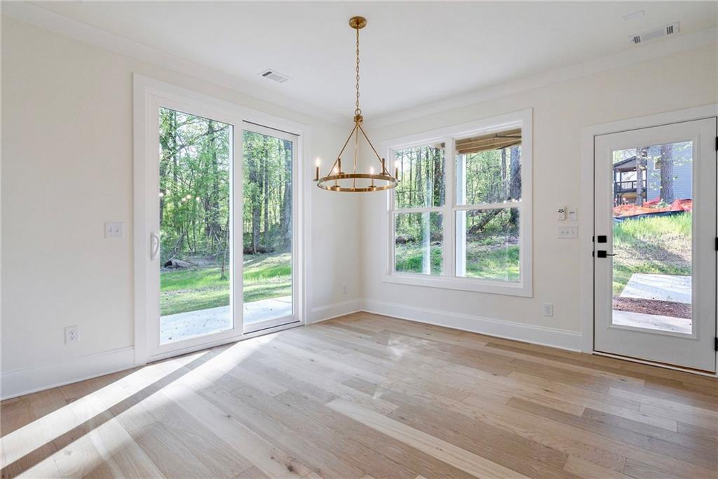 1709 Eastside Parc Street Atlanta, GA 30316 - Photo 20 of 38 a dining room with wooden floor windows and outdoor view