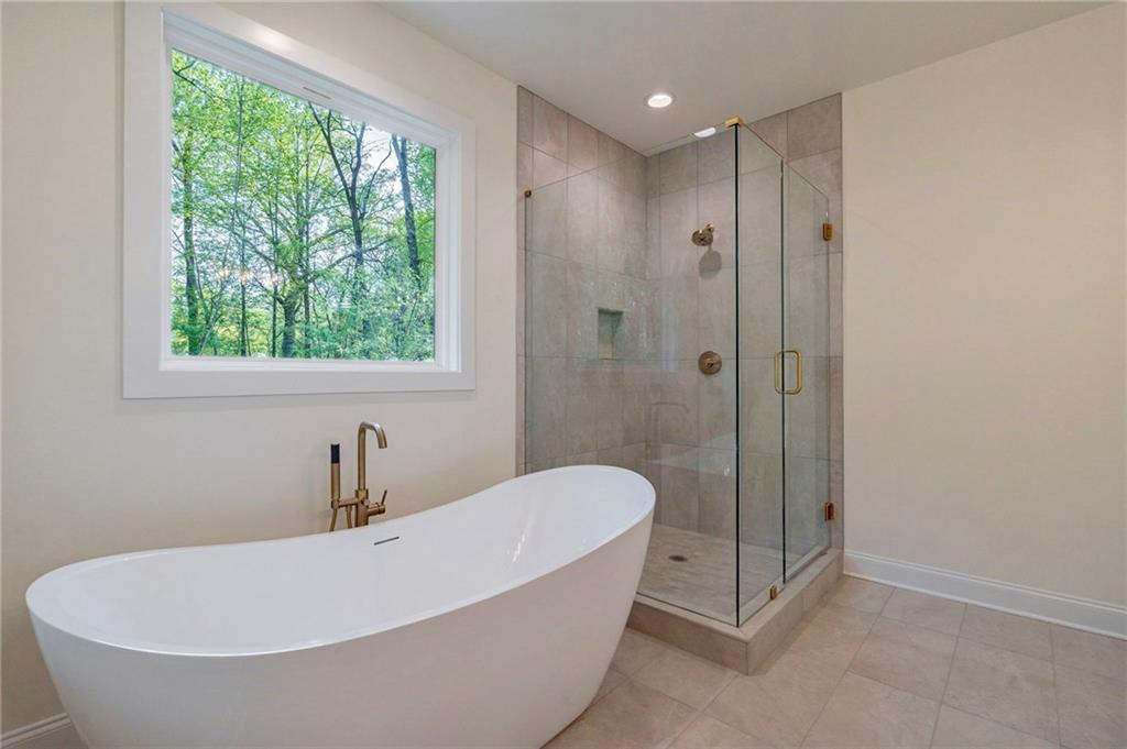 1709 Eastside Parc Street Atlanta, GA 30316 - Photo 29 of 38 a bathroom with a tub and a shower