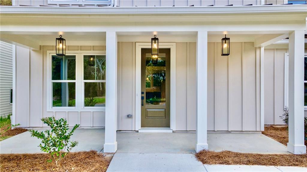 1709 Eastside Parc Street Atlanta, GA 30316 - Photo 3 of 38 a front view of a house with a potted plant and a window