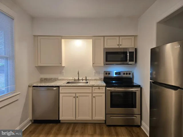 a kitchen with a sink stove and refrigerator