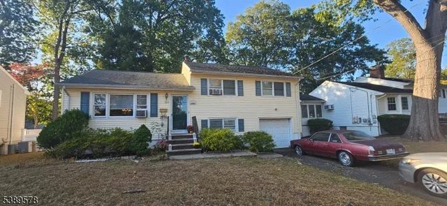 a front view of a house with parking space