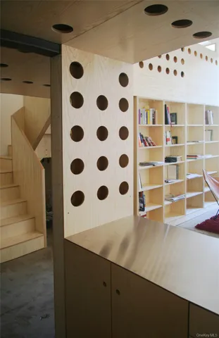 a view of a workspace with furniture and a window