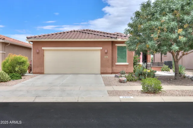 a front view of a house with a yard and garage