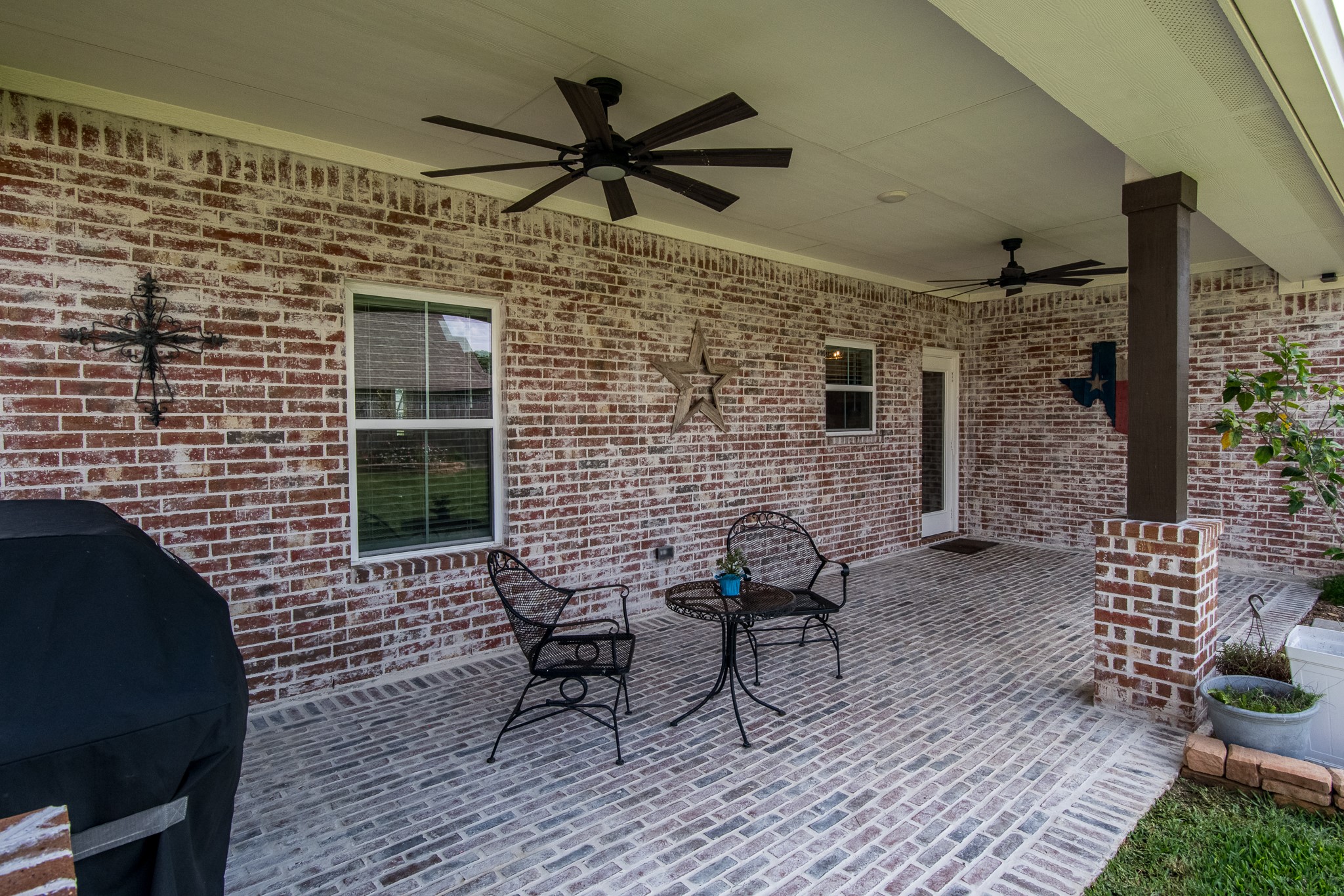 1 Greystone Court Angleton, TX 77515 - Photo 21 of 28 Back porch upgraded with brick and motor flooring. Also dual ceiling fans added