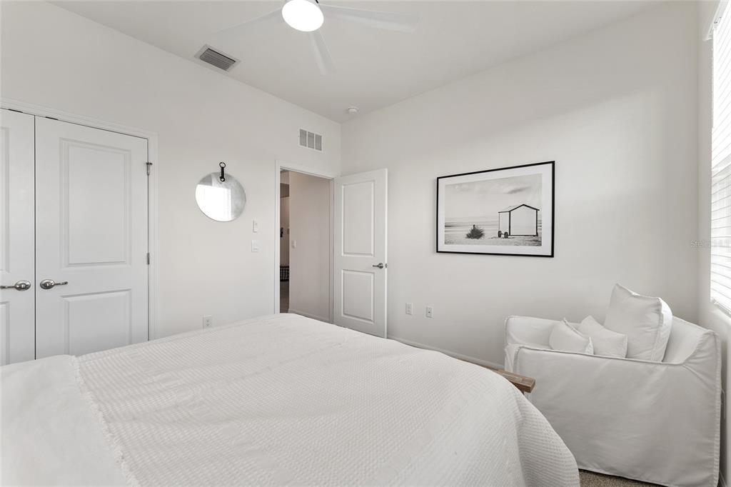 4932 Northwest 39th Loop Ocala, FL 34482 - Photo 42 of 64 a bedroom with bed and a chandelier