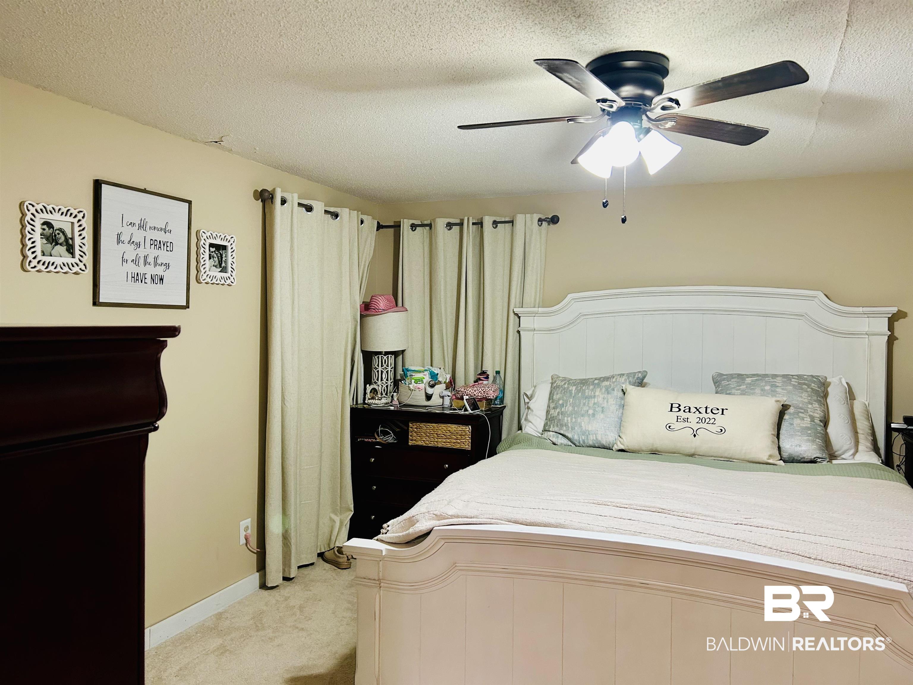 3850 Newman Road Mobile, AL 36695 - Photo 9 of 27 Bedroom with ceiling fan, light colored carpet, and a textured ceiling