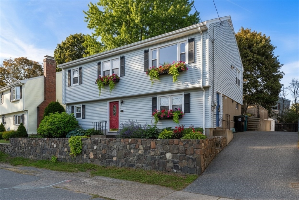 a view of a house with brick walls and potted plants