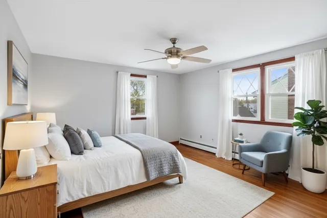 a bedroom with a large bed and windows