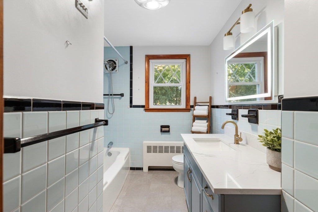 10 Horton Street Salem, MA 01970 - Photo 17 of 26 a spacious bathroom with a double vanity sink a mirror and a bathtub