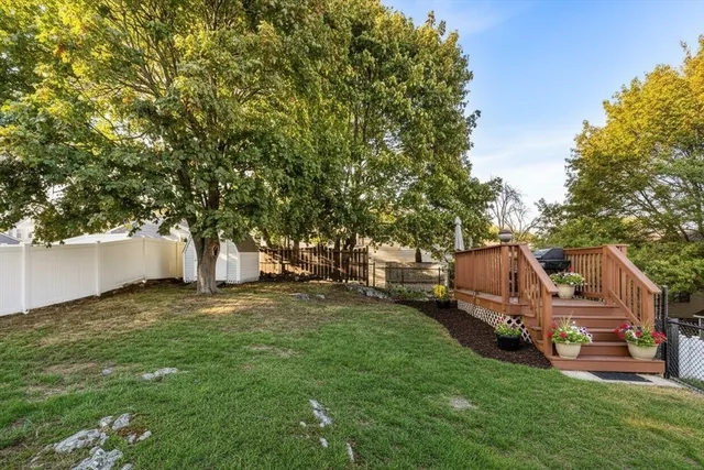 a backyard of a house with table and chairs