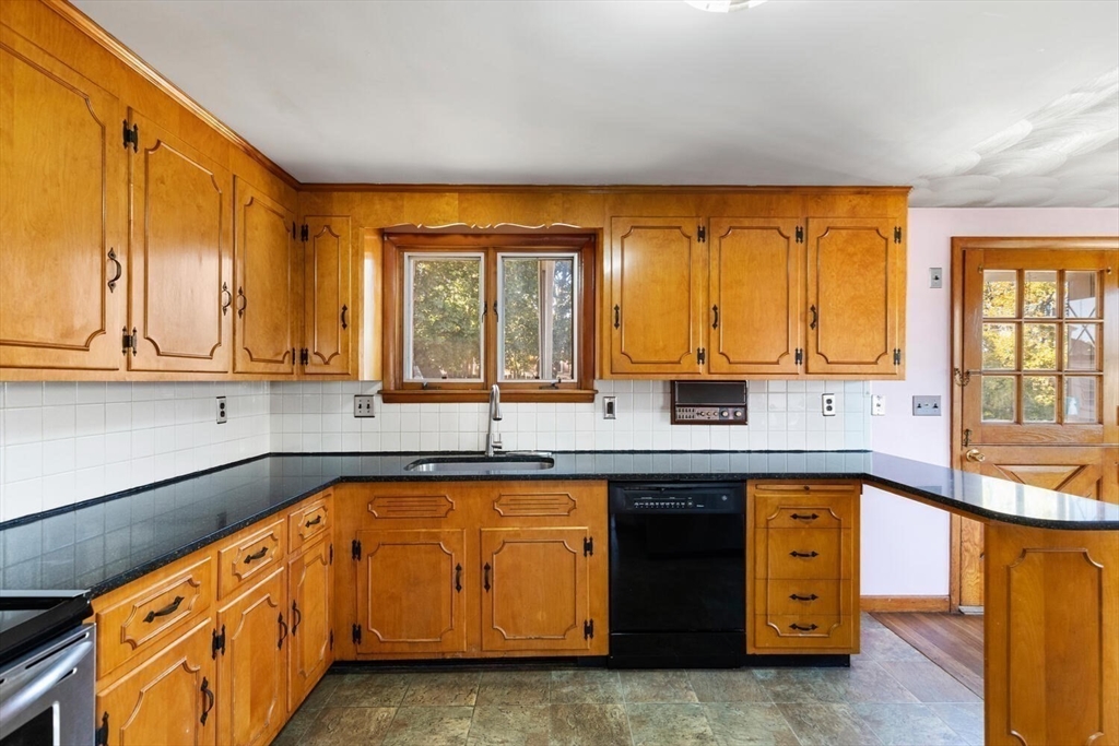 10 Horton Street Salem, MA 01970 - Photo 8 of 26 a kitchen with granite countertop a sink and cabinets