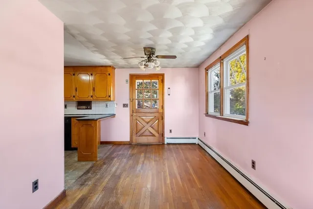 a view of a room with wooden floor and windows