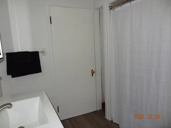 a bathroom with a sink and a shower curtain