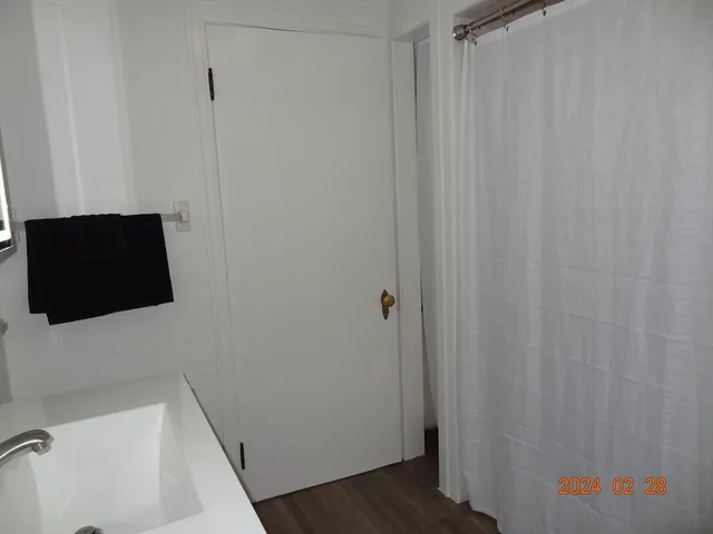 a bathroom with a sink and a shower curtain
