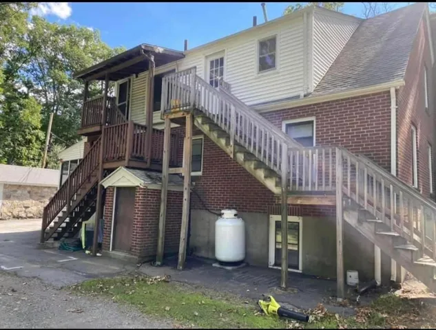 a view of a house with wooden fence