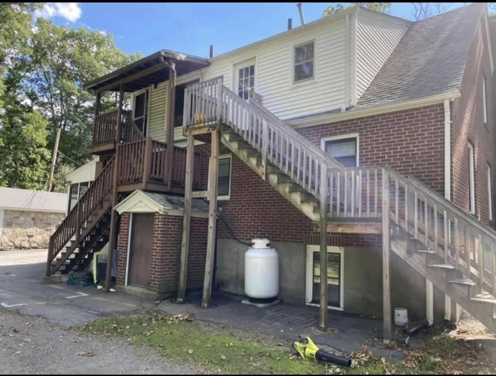 131 Worcester-Providence Turnpike, Unit 1 Millbury, MA 01527 - Photo 17 of 18 a view of a house with wooden fence