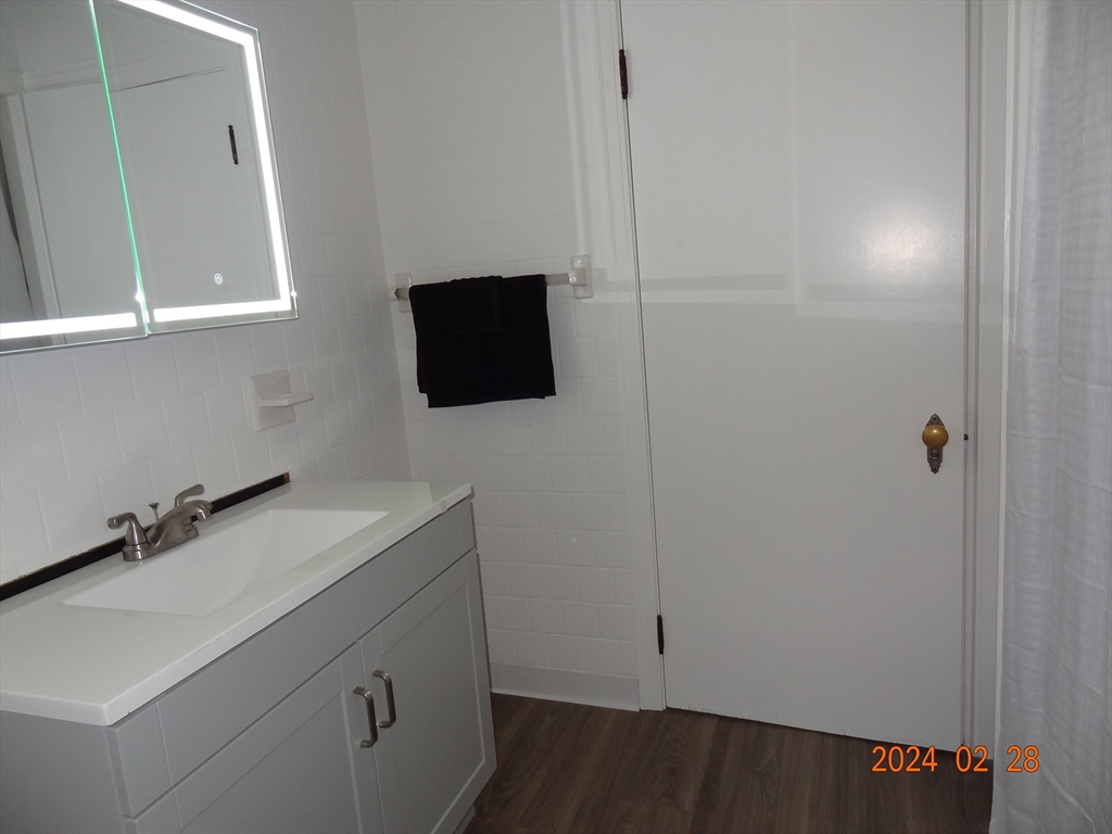 131 Worcester-Providence Turnpike, Unit 1 Millbury, MA 01527 - Photo 8 of 18 a bathroom with a sink and a mirror