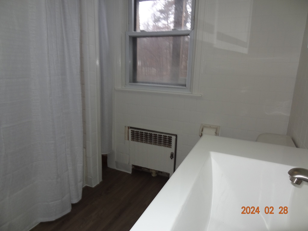 131 Worcester-Providence Turnpike, Unit 1 Millbury, MA 01527 - Photo 10 of 18 a view of hallway with window and wooden floor