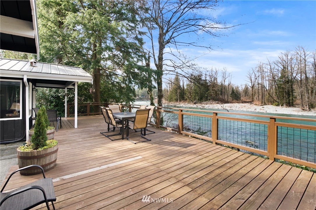 43825 Fir Road Gold Bar, WA 98251 - Photo 1 of 35 a roof deck with table and chairs and wooden floor