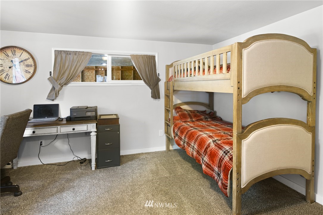 43825 Fir Road Gold Bar, WA 98251 - Photo 25 of 35 a bedroom with a bed and a chandelier