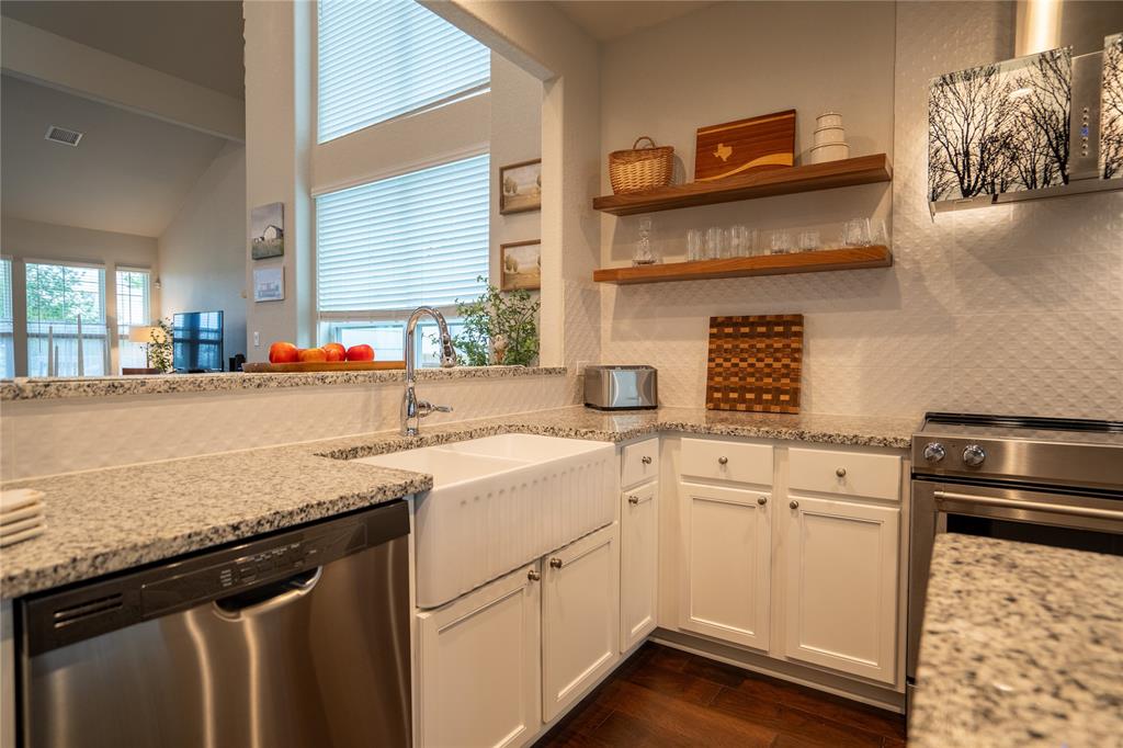 1215 Davis Street Taylor, TX 76574 - Photo 11 of 31 a kitchen with stainless steel appliances granite countertop a sink stove and cabinets
