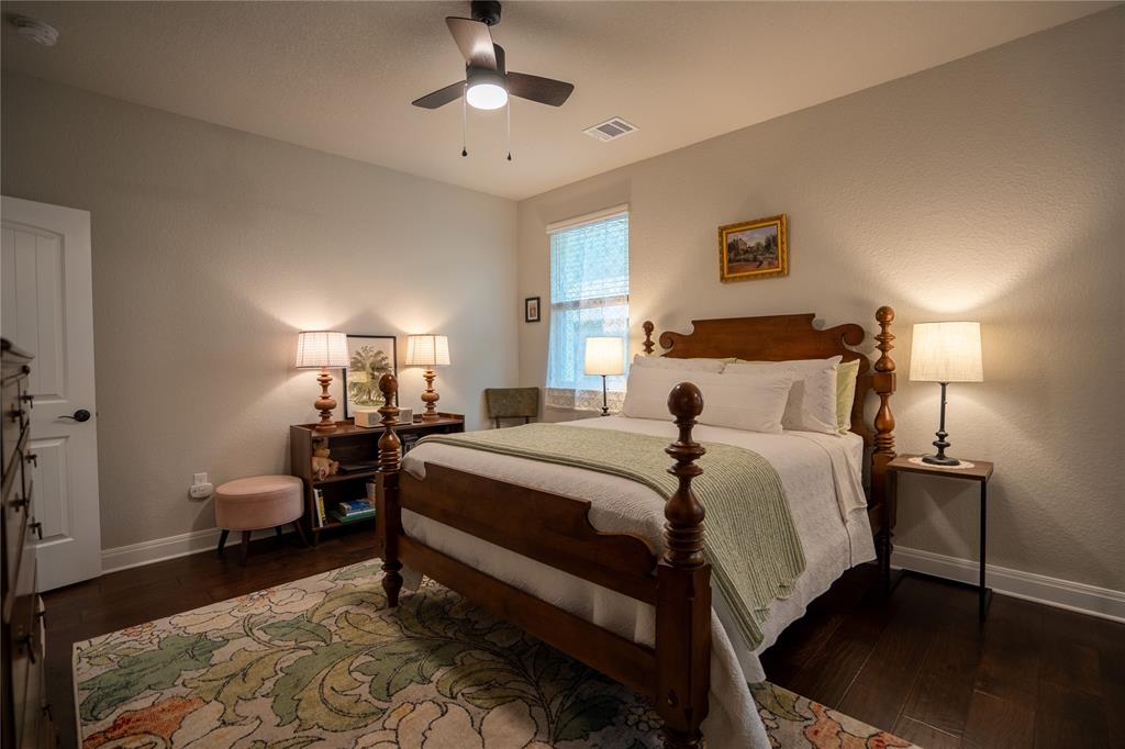 1215 Davis Street Taylor, TX 76574 - Photo 16 of 31 a bedroom with bed and a chandelier