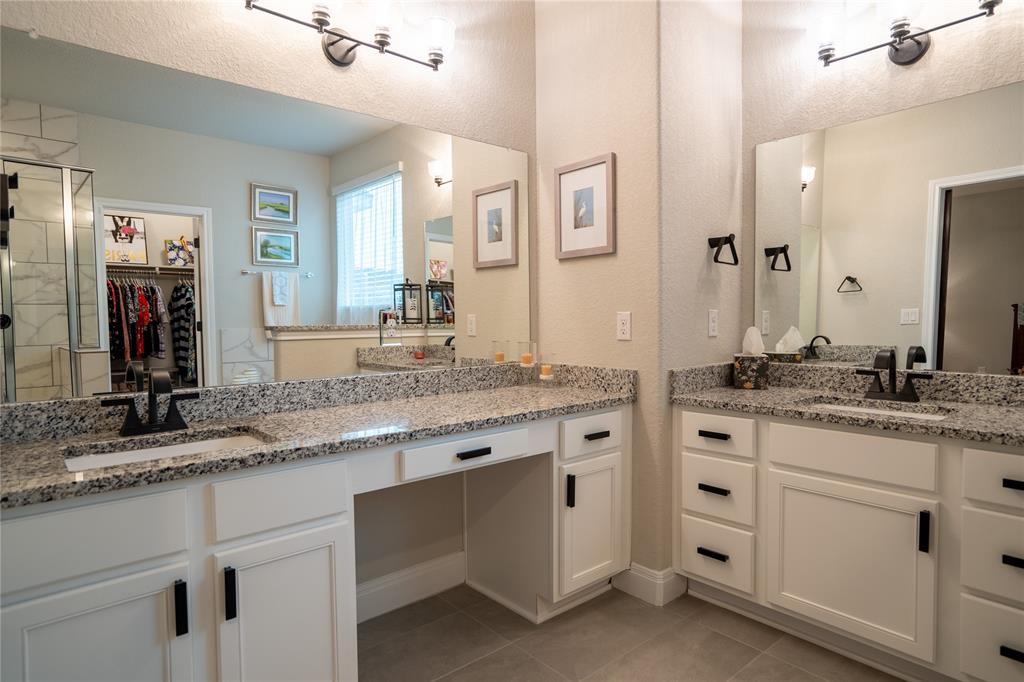 1215 Davis Street Taylor, TX 76574 - Photo 18 of 31 a bathroom with a granite countertop sink and a mirror