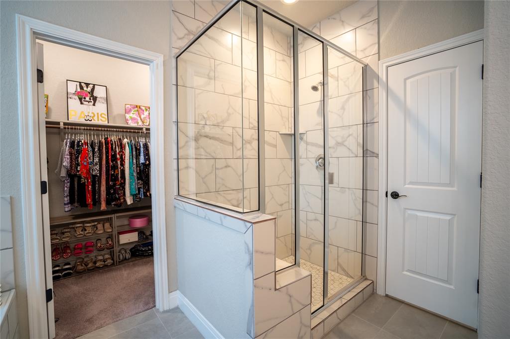 1215 Davis Street Taylor, TX 76574 - Photo 19 of 31 a view of walk in closet with clothes and shoes