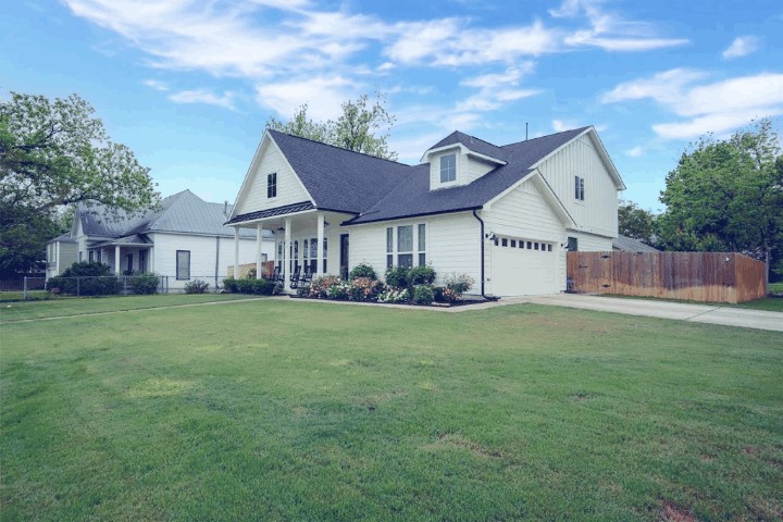 1215 Davis Street Taylor, TX 76574 - Photo 2 of 31 a view of a house with a big yard and large tree
