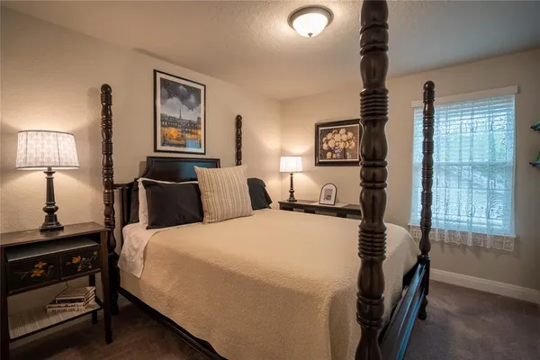 a bedroom with bed and window