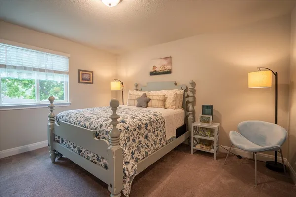 a bedroom with a bed and a chair