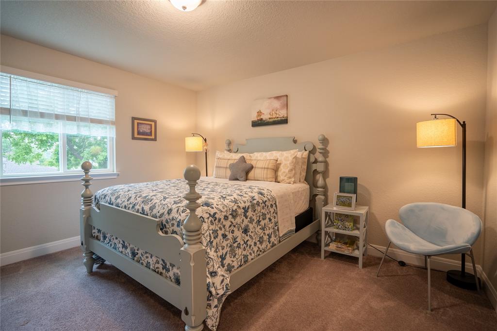 1215 Davis Street Taylor, TX 76574 - Photo 28 of 31 a bedroom with a bed and a chair