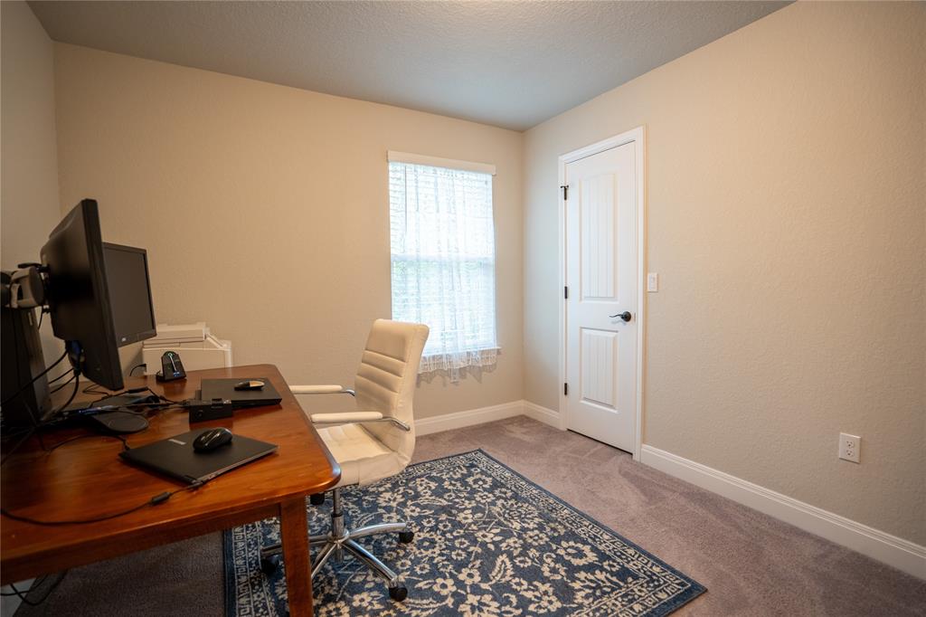1215 Davis Street Taylor, TX 76574 - Photo 30 of 31 a view of a workspace with furniture and a window
