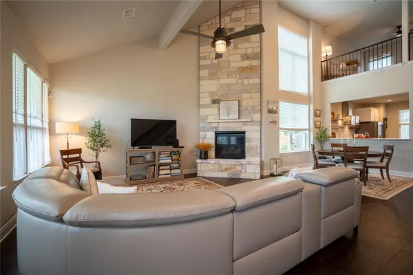 a living room with furniture a flat screen tv and a fireplace