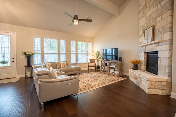 a living room with furniture fireplace and flat screen tv