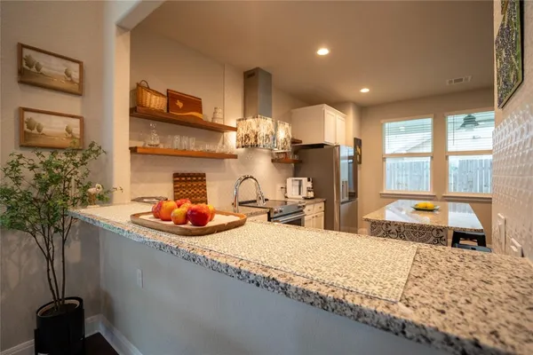 a bedroom with furniture and a large window