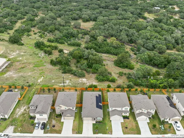an aerial view of residential houses with outdoor space