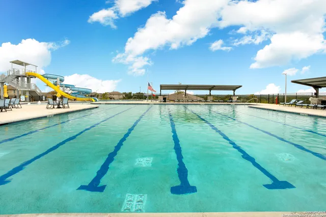 a view of swimming pool with a table and chairs