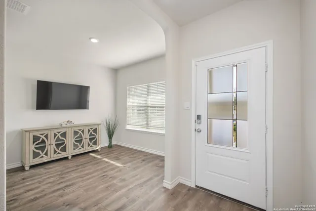 a living room with furniture wooden floor and flat screen tv