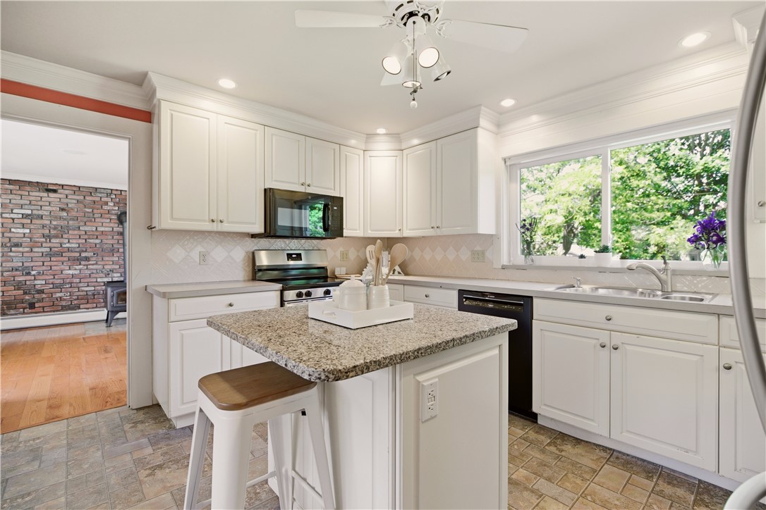 5 Heritage Road Bristol, RI 02809 - Photo 12 of 50 Kitchen with view toward den with woodstove