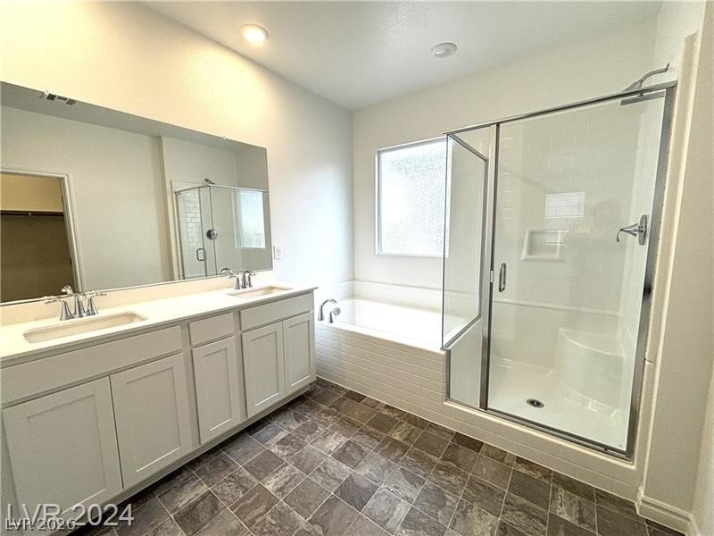 8336 Rowan Rdg Avenue Las Vegas, NV 89147 - Photo 10 of 15 This bright bathroom features a spacious shower and a vanity with dual sinks.