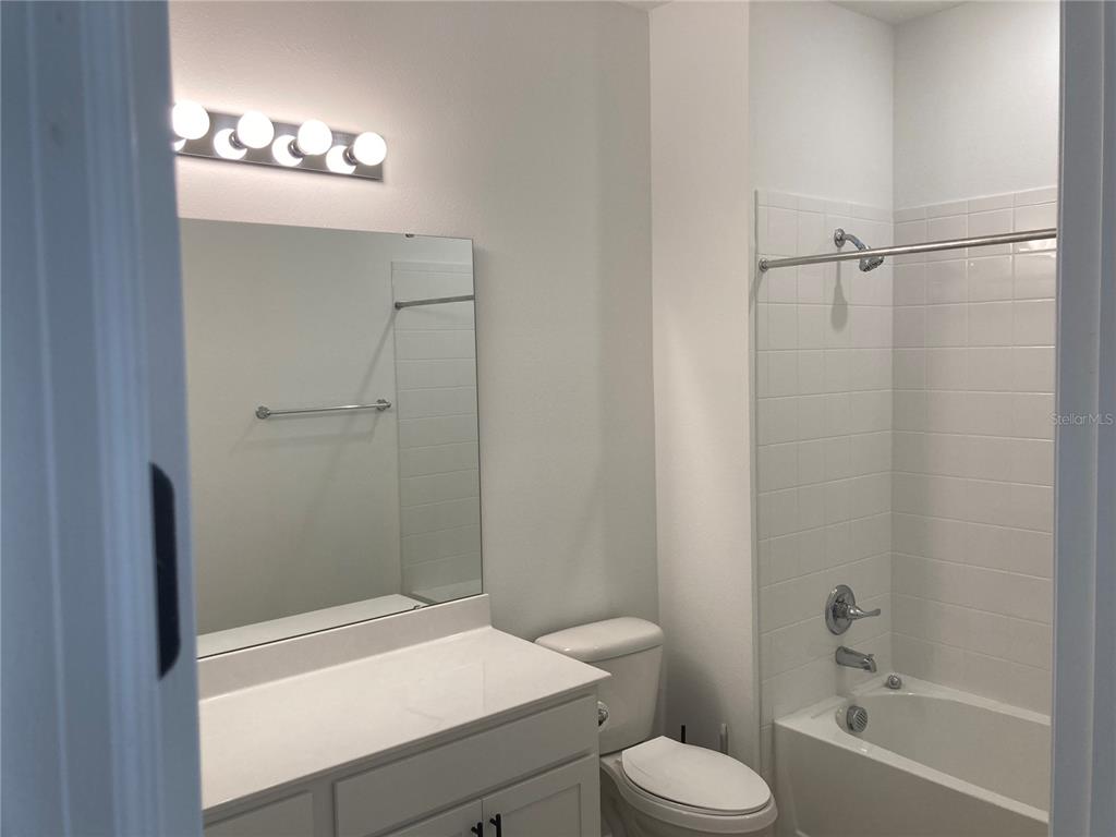 10337 Church Hammock Road Leesburg, FL 34788 - Photo 14 of 21 a bathroom with a sink a toilet and shower