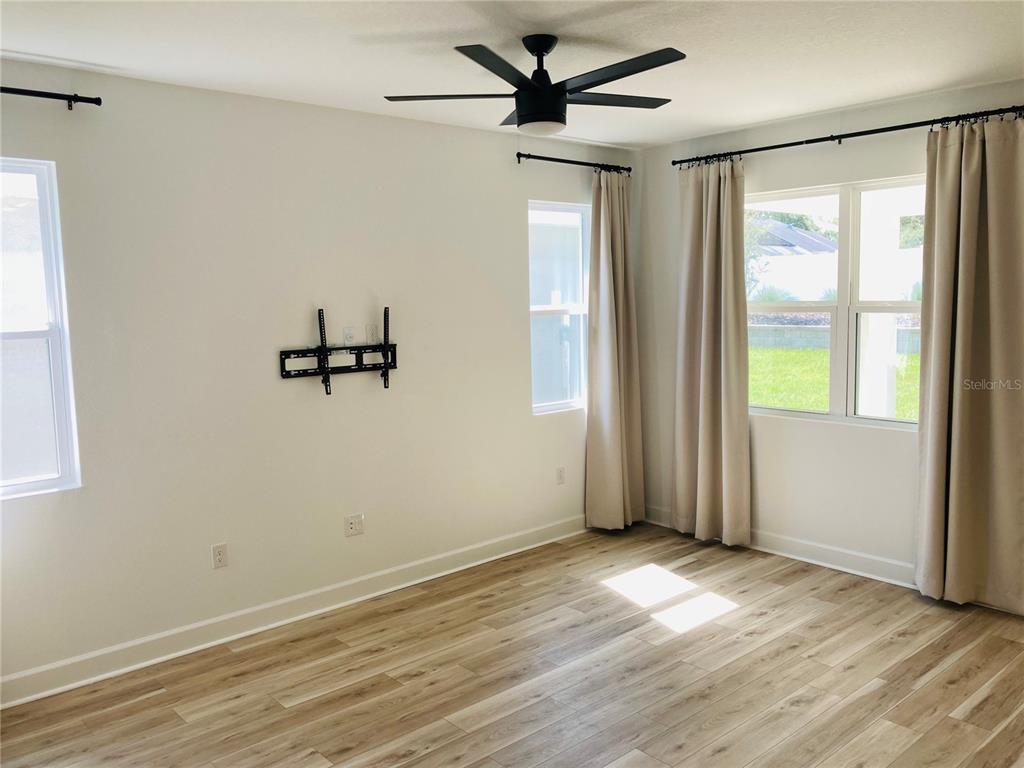10337 Church Hammock Road Leesburg, FL 34788 - Photo 16 of 21 wooden floor in an empty room with a window