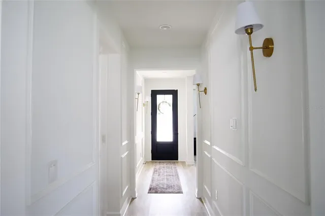 a view of hallway with wooden floor