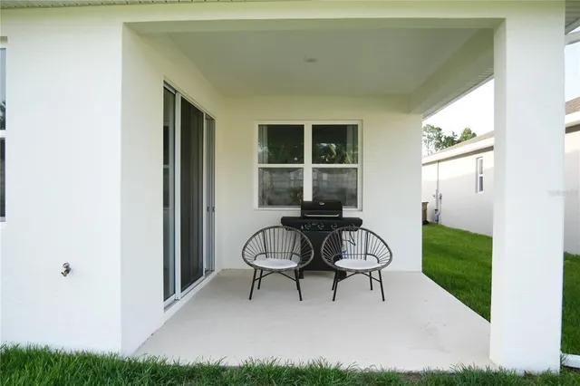 a view of a porch with furniture and garden