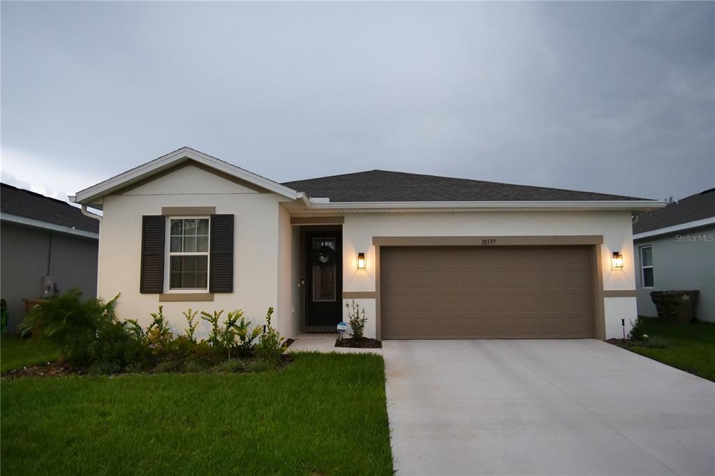 10337 Church Hammock Road Leesburg, FL 34788 - Photo 21 of 21 a front view of a house with a yard and garage