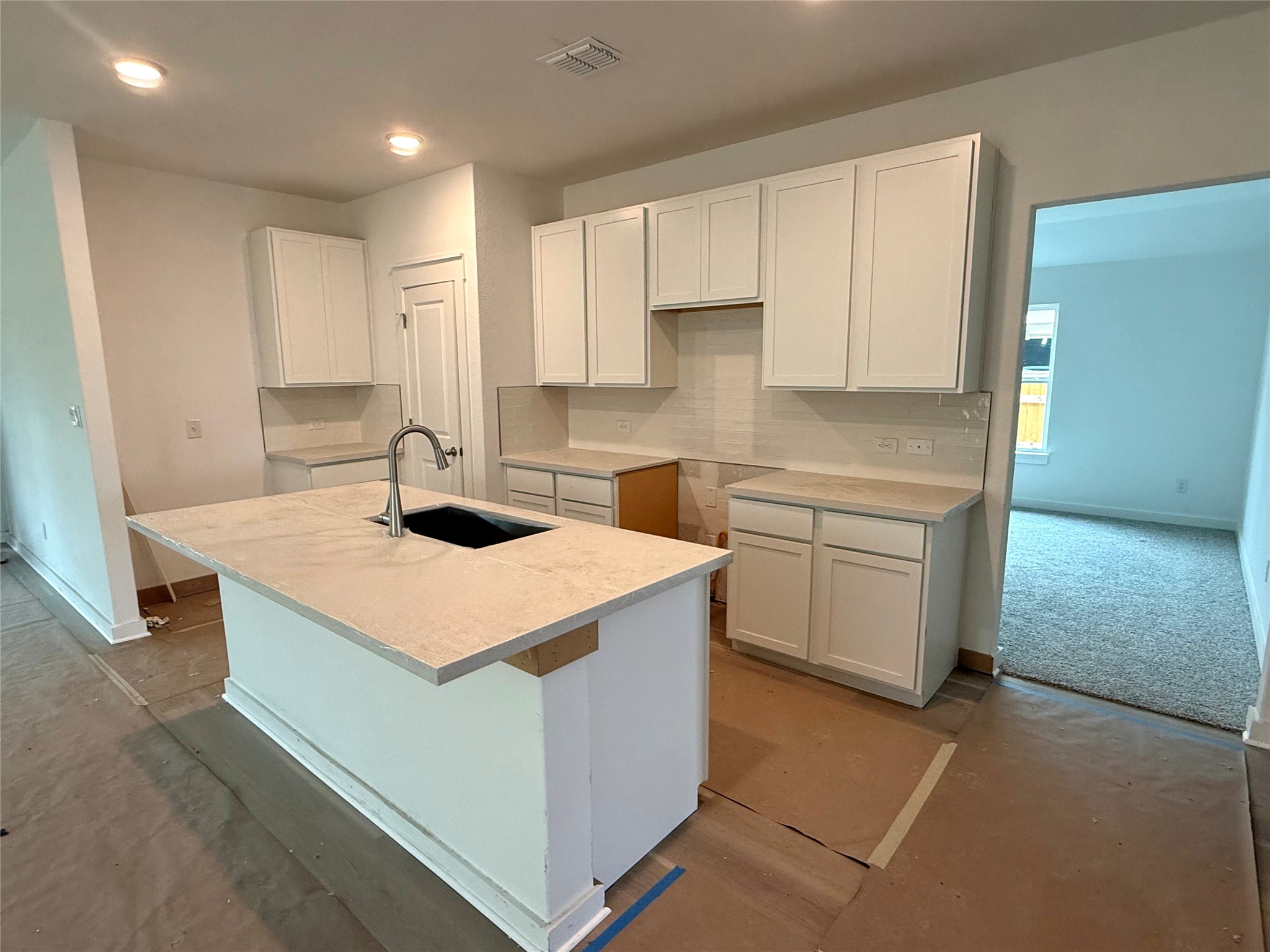 13615 Barn Chime Street Elgin, TX 78621 - Photo 2 of 8 a kitchen with a sink a stove and cabinets