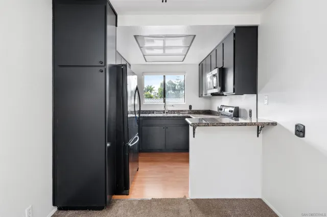 a kitchen with a refrigerator and a sink
