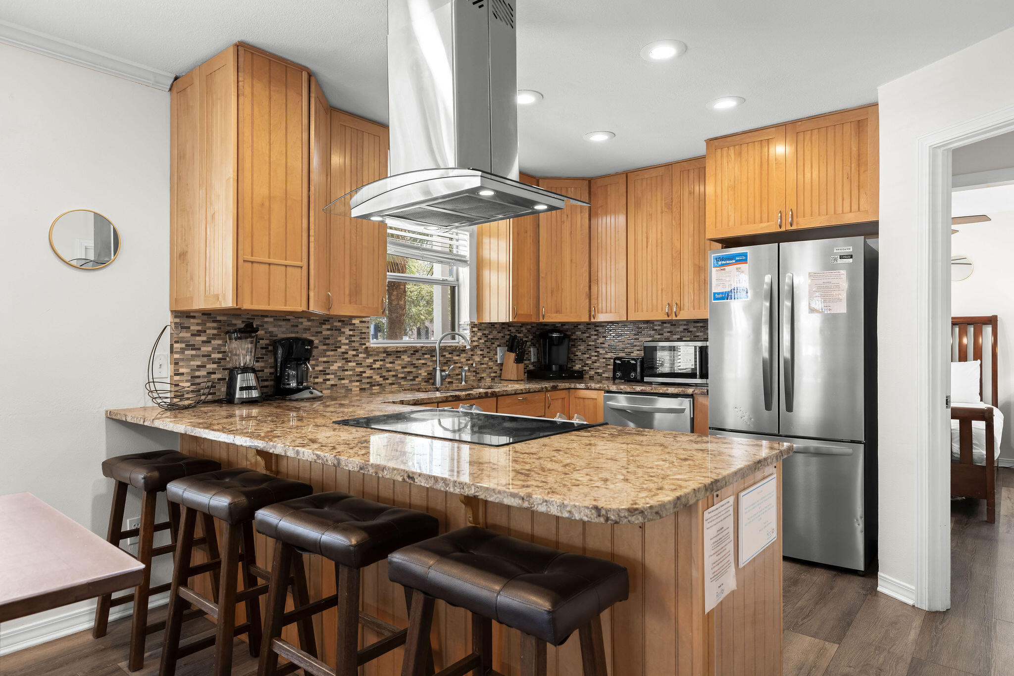 91 Matthew Boulevard Destin, FL 32541 - Photo 22 of 85 a kitchen with stainless steel appliances granite countertop a table chairs sink refrigerator and microwave